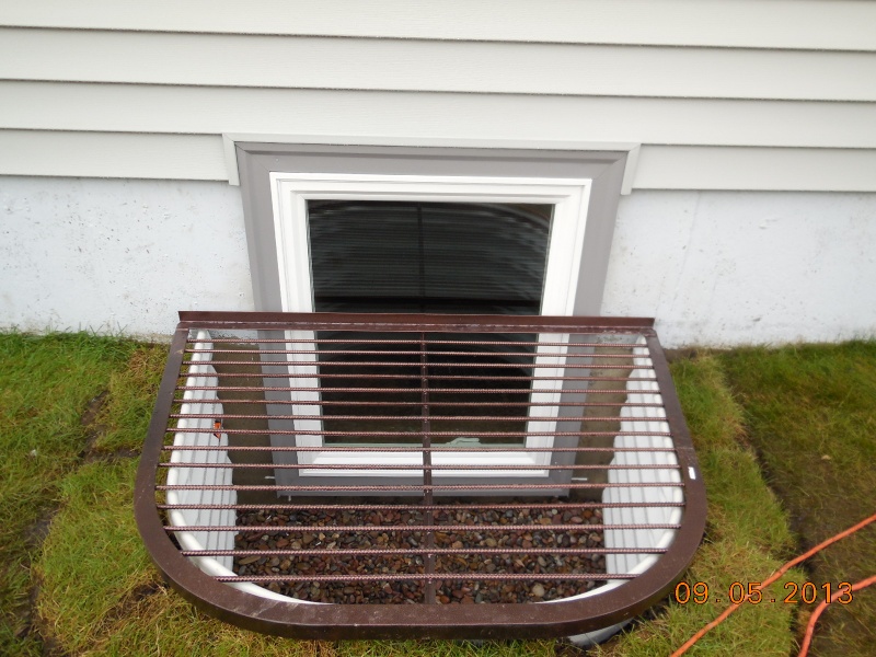 egress window with aluminum wraps and vinyl siding